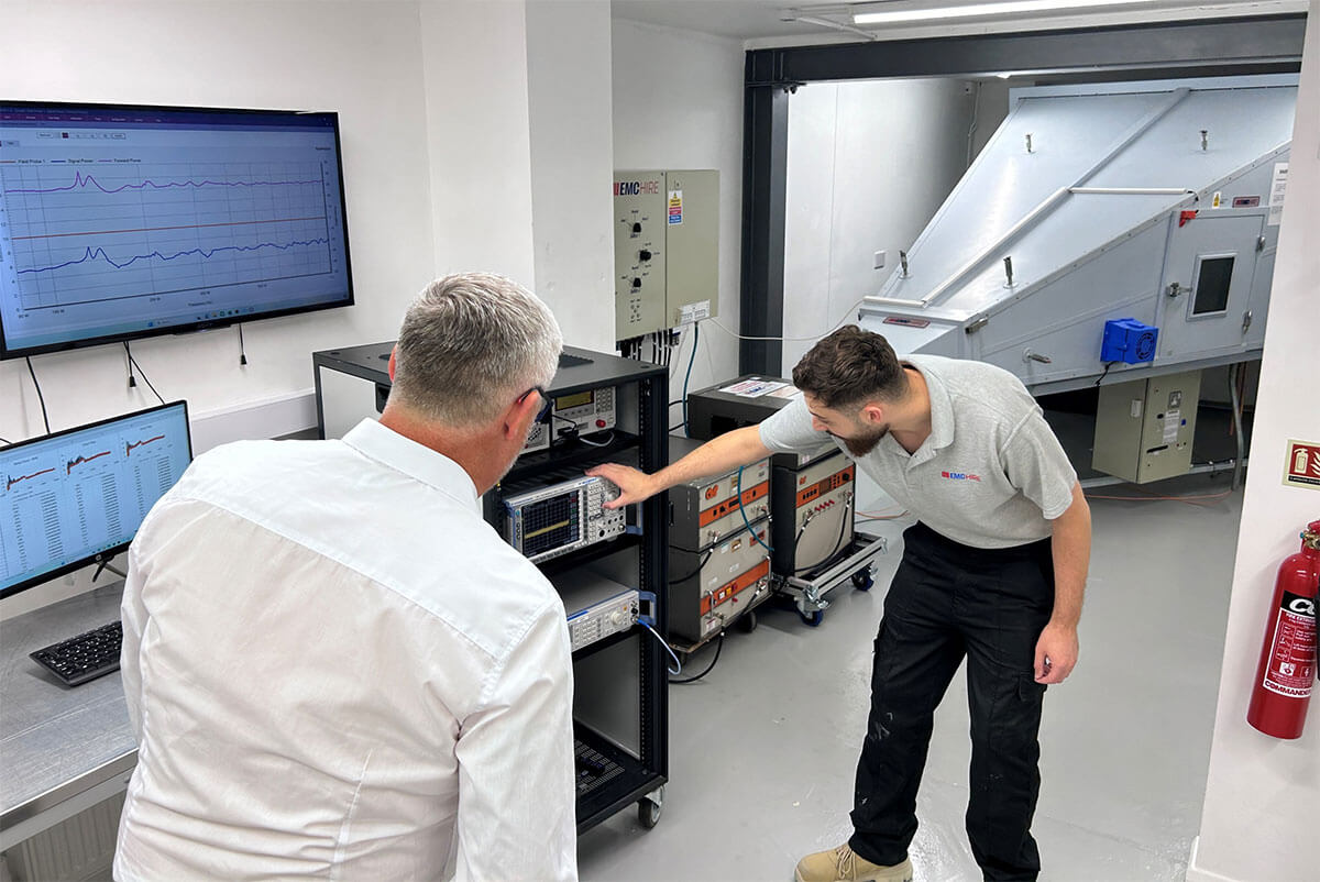 Engineer working with specialist EMC test equipment in a professional lab environment